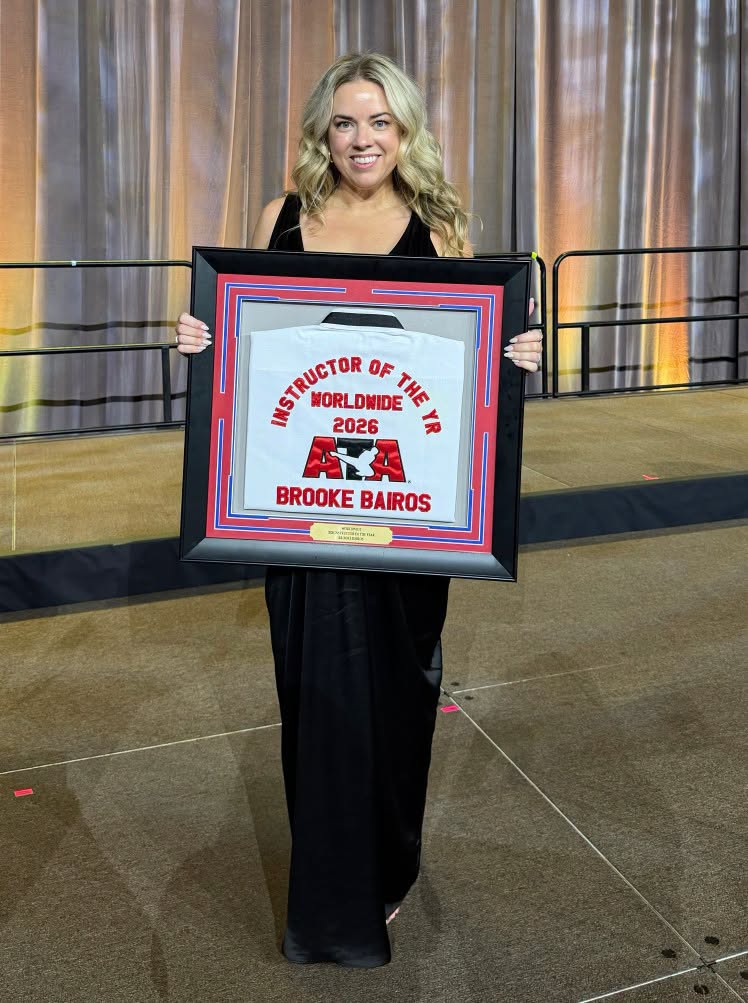 Master Brooke Bairos holding her 2026 ATA Worldwide Instructor of the Year award